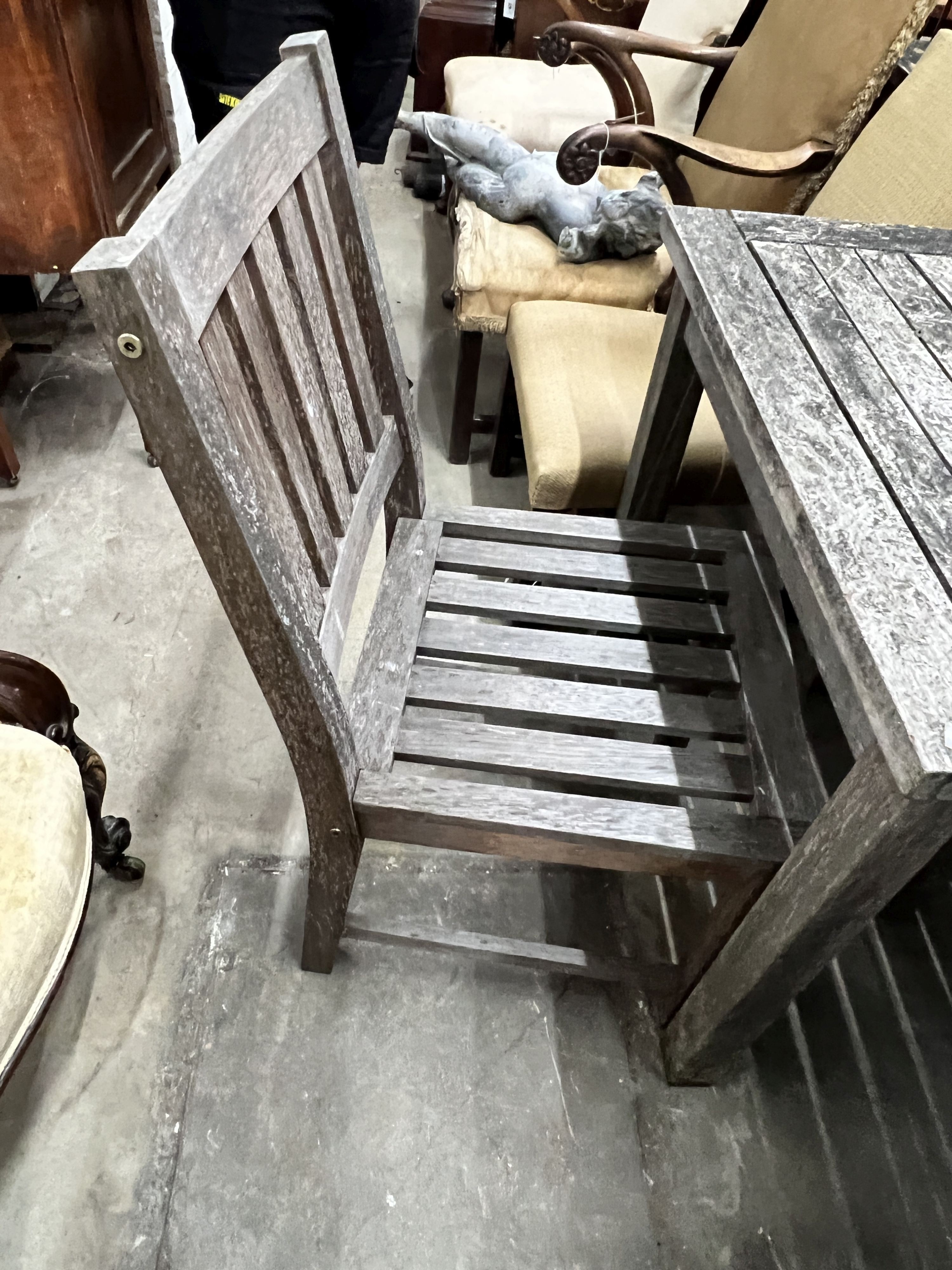 A square weathered teak garden table, width 80cm, height 73cm together with two teak garden chairs